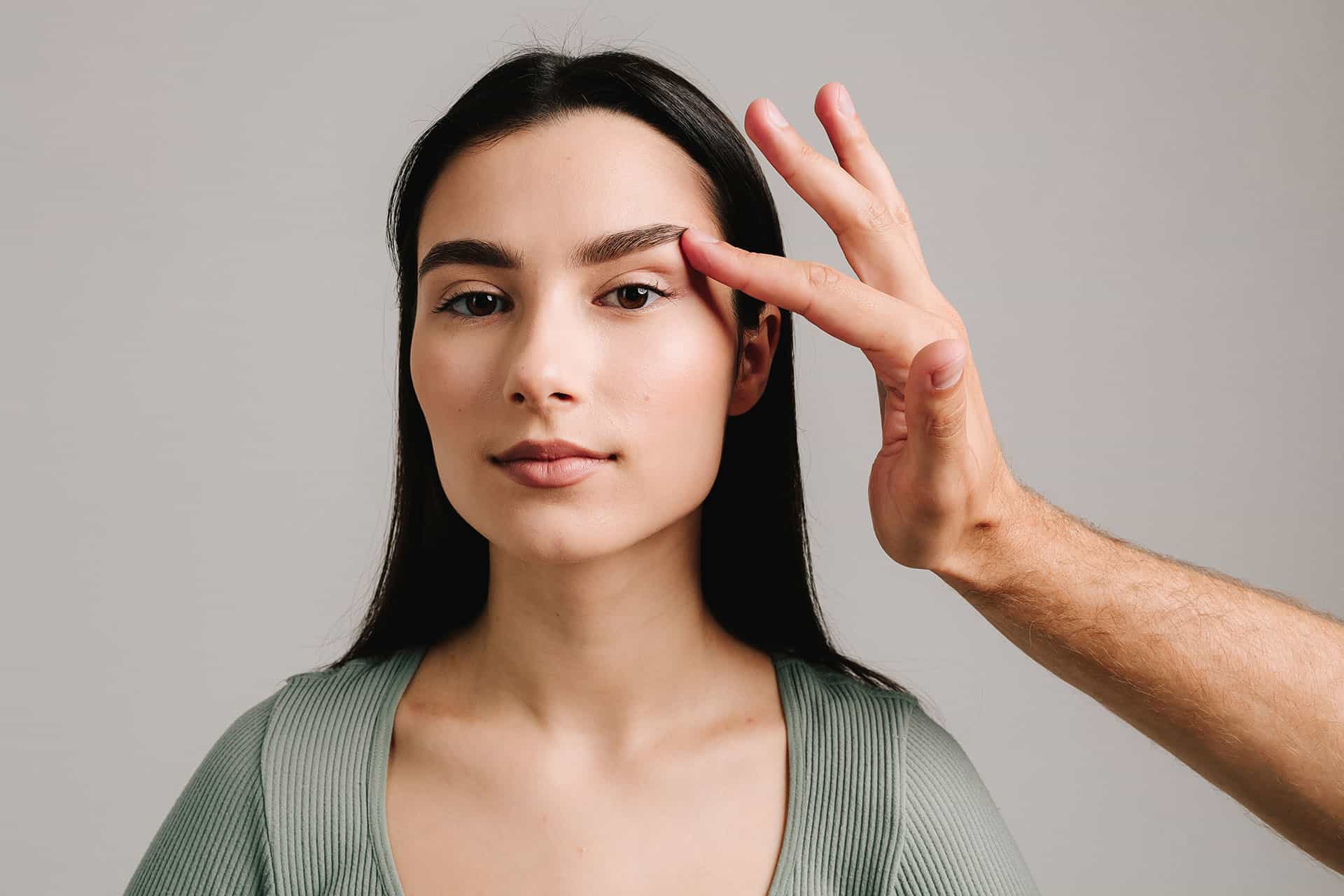 A woman with lifted eyelids, showing signs of droopy eyelids and possible ageing or health concerns - Cienna Aesthetics Medical Clinic